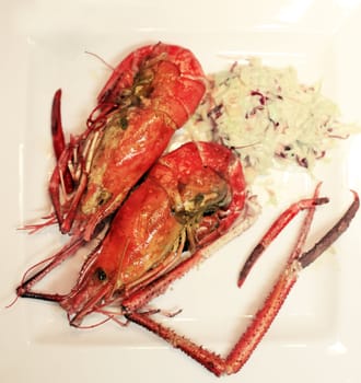 two prawns on a plate with lettuce