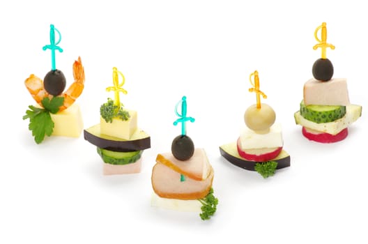 Close-up of canape with olives, cheese and over white