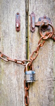 Close up background image of a wooden gate chained and locked
