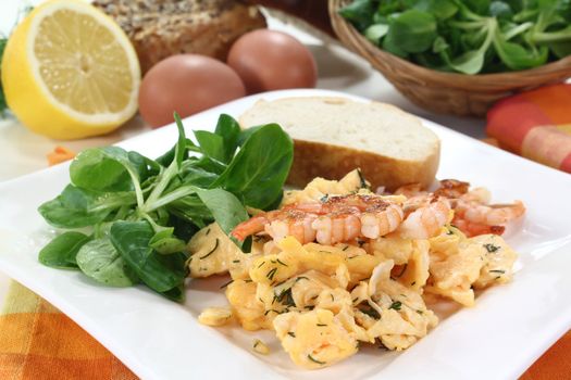 Scrambled eggs with shrimp, dill and corn salad on a plate