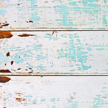 Weathered wood with peeling paint as a textured background