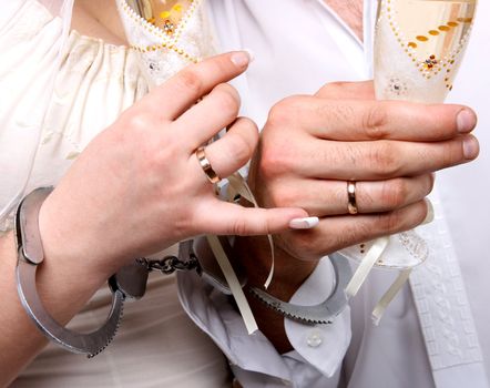 Wedding. Hands in handcuffs newlyweds
