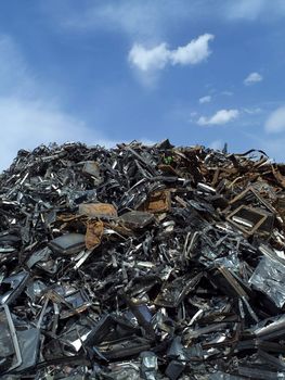 Stack of Metal Garbage in front of blue sky