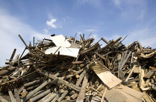 Heap of Wood Garbage in front of blue sky