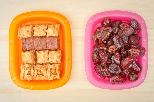 Plates of baqlawa and dates, typical of food eaten in Ramadan and Eid festivlas