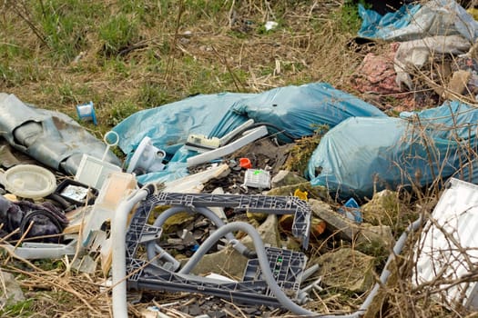wild refuse heap left near the road throws litter about