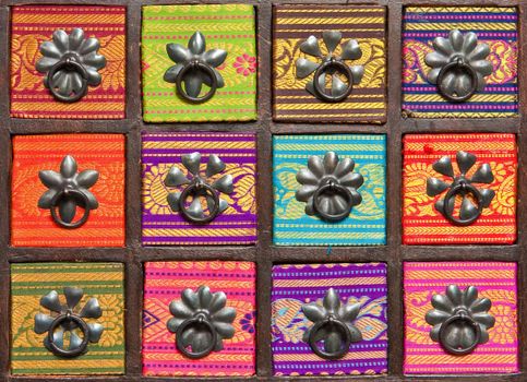 Colorful drawers of a spice cabinet as a detailed background