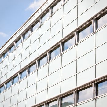 Close up of an ultra-modern building against a bright blue sky