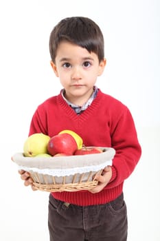 Child bringind basket fruit on white background