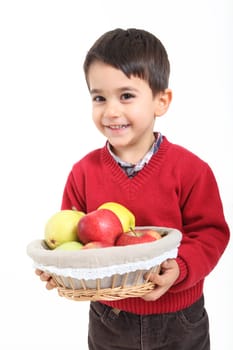 Child bringind basket fruit on white background