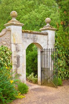 A nice gate in a stone wall in an english garden