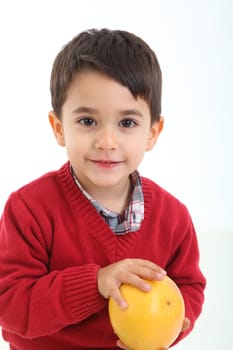 A child with a grapefruit on white background
