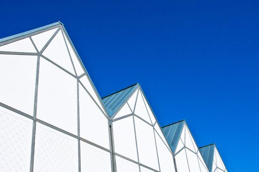A striking image of modern white architecture against a bright blue sky