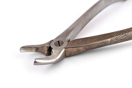 old dental pliers on a white background