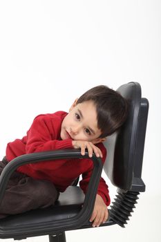 Child sitting like a boss on white background