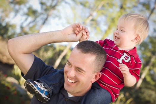 Young Laughing Father and Child  Having Piggy Back Fun.