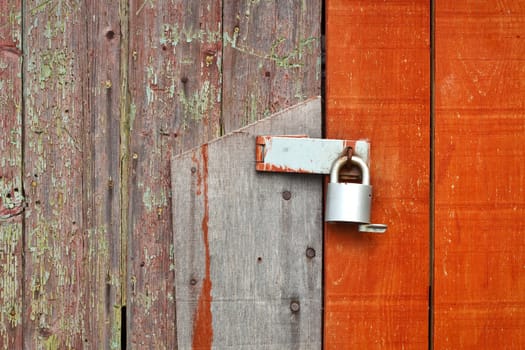 Locked wooden barn door with detailed texture and colour contrast