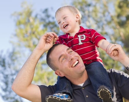 Young Laughing Father and Child  Having Piggy Back Fun.