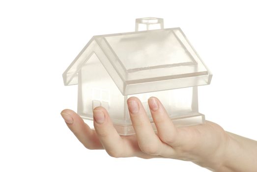 The home in human hand on white
