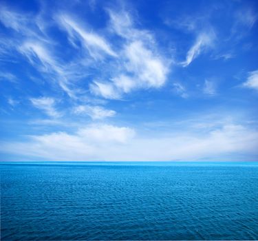 cloudy blue sky above a surface of the sea
