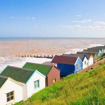 Row of colourful beach huts at Southwold, England