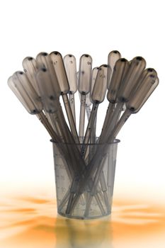 Zoomed shaded pipettes standing placed in measure glass