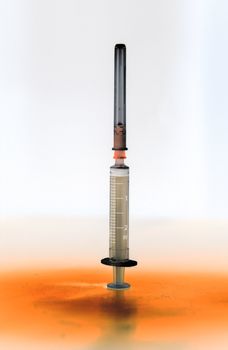 Shaded and isolated medical syringe standing head up