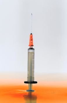 Shaded and ready medical syringe standing head up