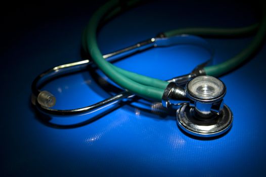 Isolated green stethoscope waiting for patients to inspect