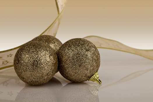 Gold Christmas Baubles with gold ribbon.