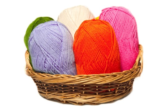 isolated colorful acrylic fibers in the basket on white background