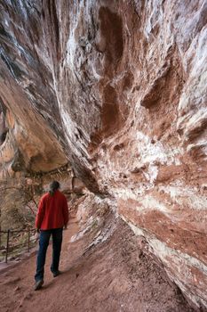 Tourist walking under the rock in Zion National Park