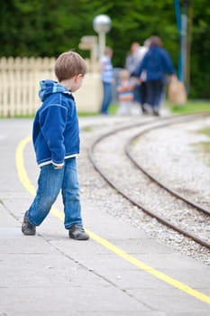 Little boy waiting for a train