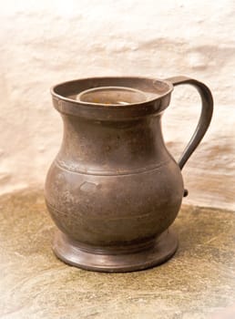 Old jug on a stone surface