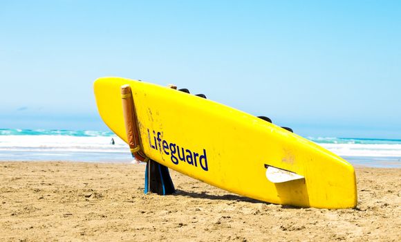 Yellow surfboard on a beach