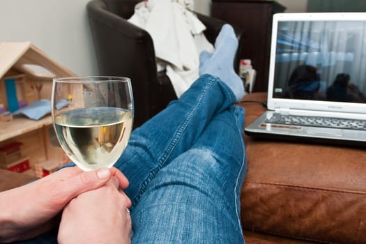 A housewife puts her feet up at home after a long day of housework.