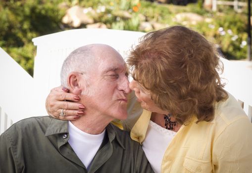 Happy Senior Couple Kissing in the Park.