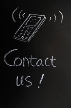 Contact us - text written in chalk on a blackboard