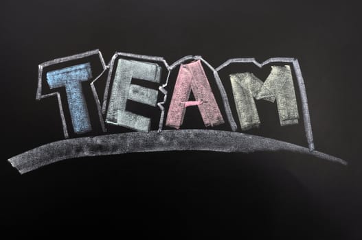 Team word of colorful letters written in chalk on a blackboard