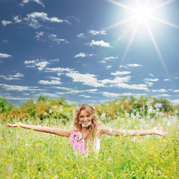  Blonde starts soap bubbles in a green field