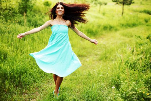 happy woman dancing on grass