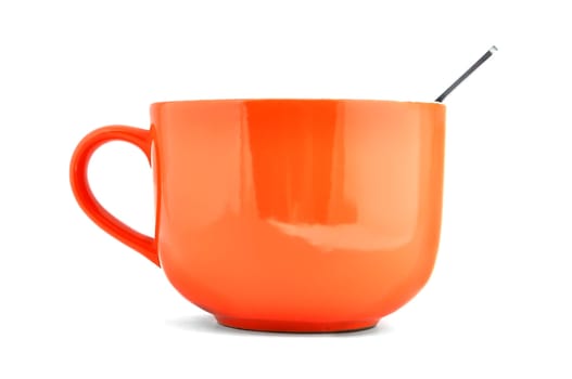 empty orange cup and spoon on a white background