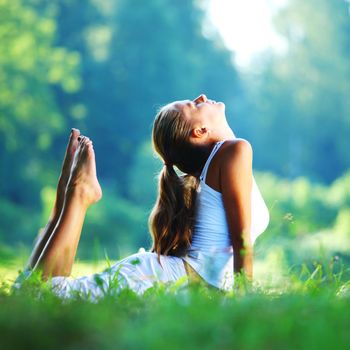 yoga woman on green park background