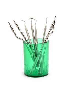 tools  for sinus lifting in a green glass