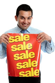 A male salesman holding a sale sign and smiling.