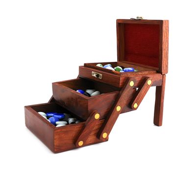 wooden box with colored stones on a white background