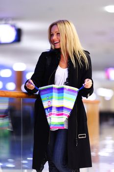 woman in shop center holds the bag in hands