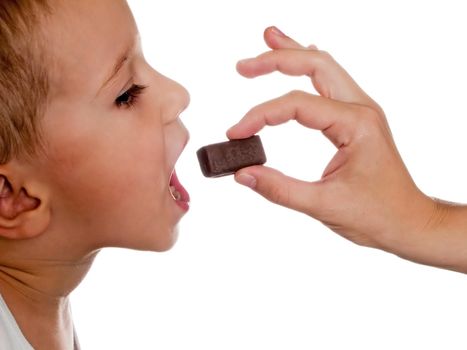 Human hand holding one sweet chocolate candy food