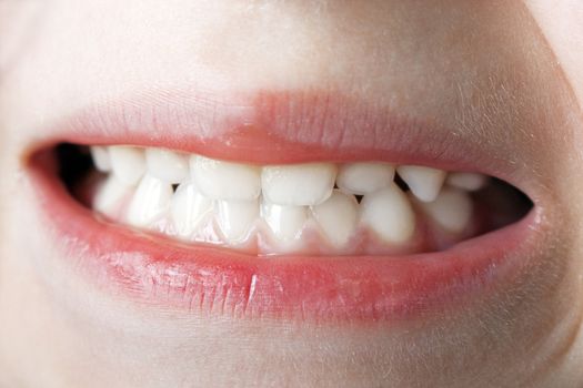 Little human baby child teeth mouth on face macro