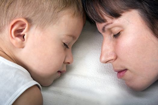 Sleeping mother and cute child in family love life